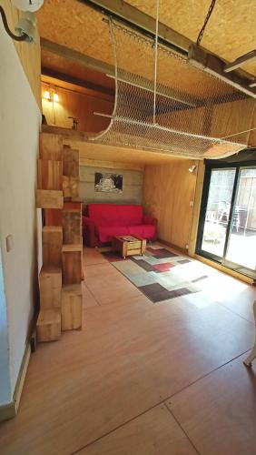 a living room with a couch and a net at A Cabaña do Cumiar in Ponteareas