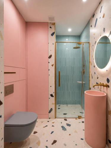 a bathroom with a rock wall and a shower at Pastel Apartment - Ergo Arena in Gdańsk