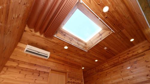 a skylight in a wood paneled room with a window at 三仙台星辰民宿 in Chenggong