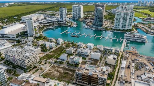 an aerial view of a city with buildings and a harbor at Luxury Retreat in Puerto Cancun with Rooftop Pool in Cancún