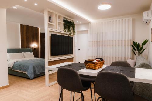 a room with a bed and a table and chairs at Lighthouse Nest AXD in Alexandroupoli