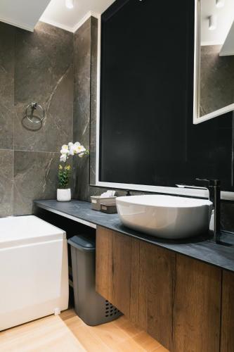 a bathroom with a large white sink on a counter at Lighthouse Nest AXD in Alexandroupoli