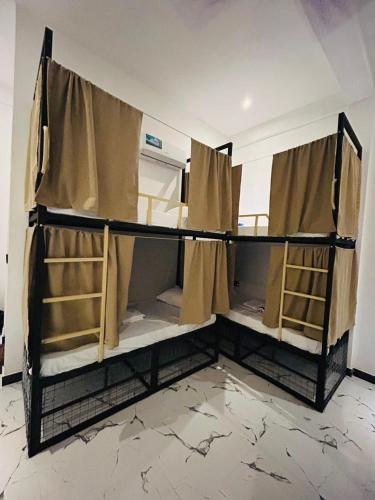 a room with two bunk beds with curtains at Wake N Flow, Arugam Bay in Arugam Bay