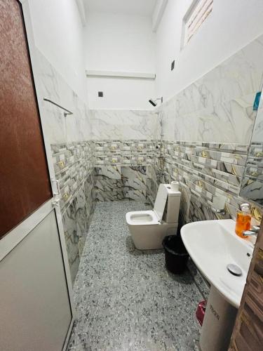 a bathroom with a toilet and a sink at Wake N Flow, Arugam Bay in Arugam Bay