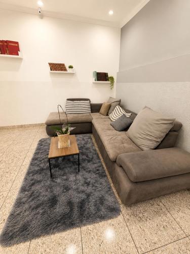 a living room with a couch and a table at Hotel Mão de Fatima in Aparecida