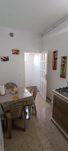 a kitchen with a table and chairs and a stove at Cockpit in Le Kram