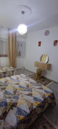 a bedroom with a bed with a quilt on it at Cockpit in Le Kram