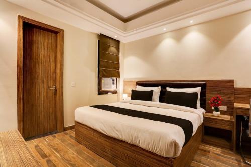 a bedroom with a large bed in a room at Collection O Stargaze in Kānpur