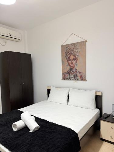 a bedroom with a bed with two towels on it at Apartments Gigu in Ksamil