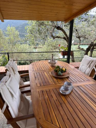a wooden table with a bowl of fruit on it at Da Ö NOXE in Bracco
