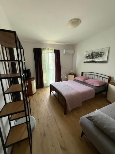 a bedroom with two beds and a ladder at Apartments Maja i Mate in Sućuraj