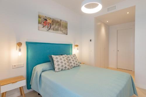 a bedroom with a blue bed in a room at Horus 054 in Torre del Mar