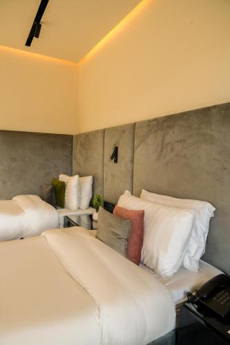 a room with two beds with white pillows at City Hotel in Abbottabad