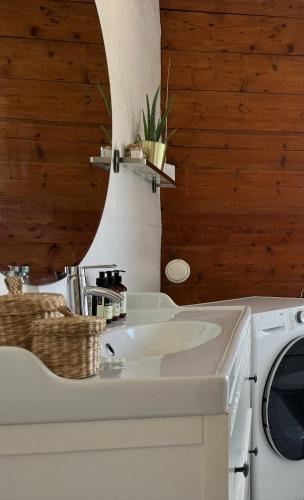 a bathroom with a sink and a washing machine at Leilighet i villa, 3 soverom med parkering-nær sentrum - Open for ONS 2026 in Stavanger