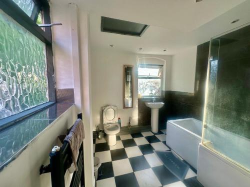a bathroom with a sink and a tub and a toilet at 1 Bed & Breakfast West Brom in West Bromwich