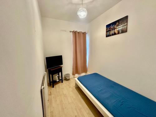 a small bedroom with a bed and a television at 1 Bed & Breakfast West Brom in West Bromwich