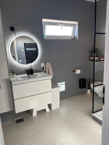 a bathroom with a white sink and a mirror at BergÁs in Njarðvík