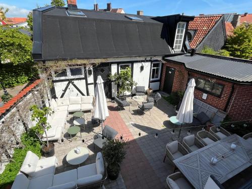 an aerial view of a patio with umbrellas and chairs at Hotell Bäckagården in Ystad
