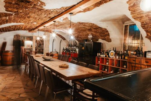 a bar with a long wooden table and chairs at Hotel Leidinger - ehemalige Domicil und Domaine Leidinger in Saarbrücken