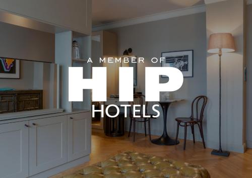Ein Mitglied des Flip Hotels-Logos in einer Küche mit Tisch und Stühlen in der Unterkunft Mimosa Hotel in Westerland