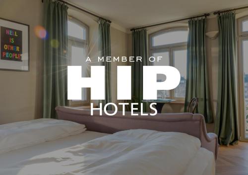 a bedroom with two beds and the words a member of dip hotels at Mimosa Suites in Westerland