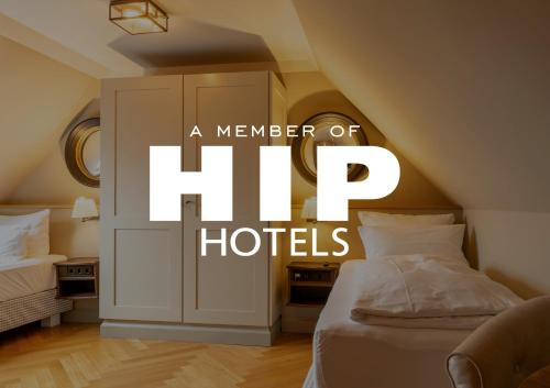 a sign that reads a member of hug hotels in a bedroom at Mimosa House in Westerland