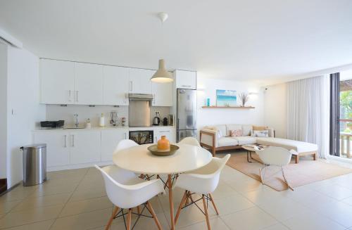 a kitchen and living room with a table and chairs at Beautiful Flat in Mont Choisy in Mont Choisy
