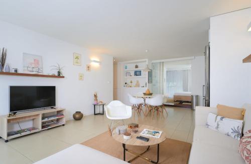 a living room with a couch and a tv at Beautiful Flat in Mont Choisy in Mont Choisy