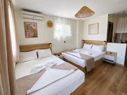 a hotel room with two beds in it at Ladario Studios in Sarti