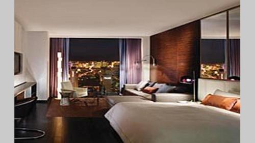 a bedroom with a large bed and a living room at Palms Place amazing Strip View 20th floor in Las Vegas
