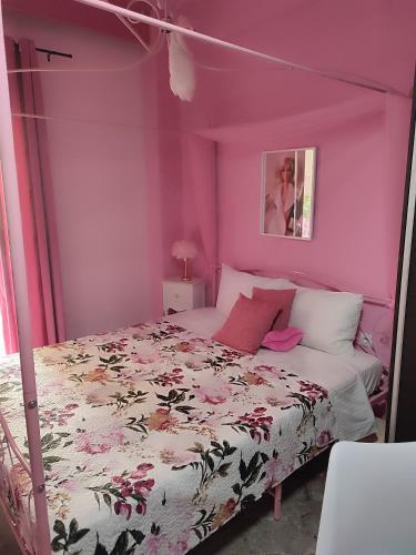 a pink bedroom with a bed with a canopy at Barbie in Veria