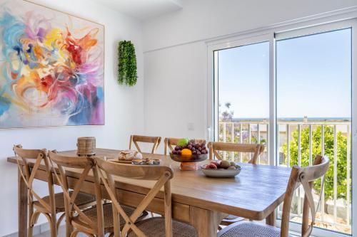 a dining room with a wooden table and chairs at Casa Alvor in Alvor
