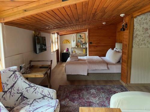 a room with a bedroom with a bed and a couch at Lapera Otel in Borçka