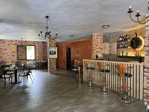 a large room with a bar and tables and chairs at Lapera Otel in Borçka