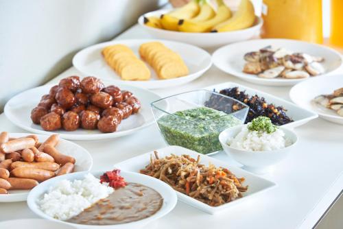 a table full of different types of food on plates at Select Inn Yonezawa in Yonezawa