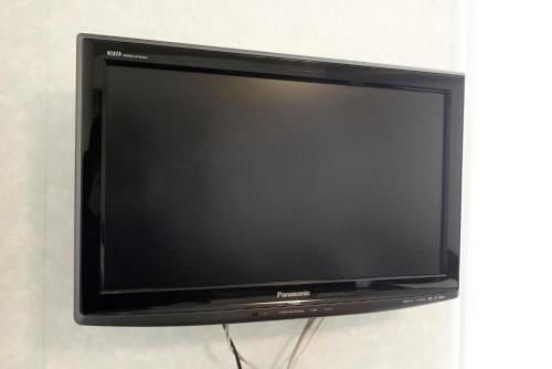 a flat screen television sitting on a wall at Select Inn Yonezawa in Yonezawa