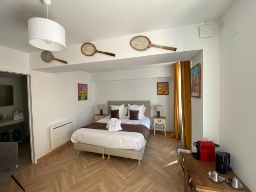 a bedroom with a large bed and a desk at Les Terres Noires in Serville