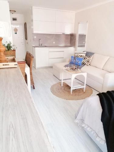 a living room with a white couch and a table at Luxury Studio with Balcony in Sunny Beach