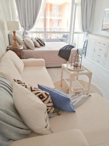 a living room with two beds and a couch at Luxury Studio with Balcony in Sunny Beach