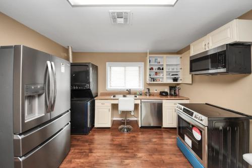a kitchen with a stainless steel refrigerator and a sink at Lofty Grace Home 2 in Richmond