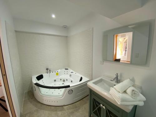 a bathroom with a bath tub and a sink at Les Terres Noires in Serville