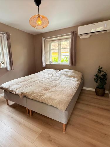 a bedroom with a bed and a window at Krummeled Rooms & Shelter by the forest in Hasle
