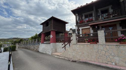 a building with a balcony on the side of a road at Casa do Lagar, Praia da Abrela in O Vicedo