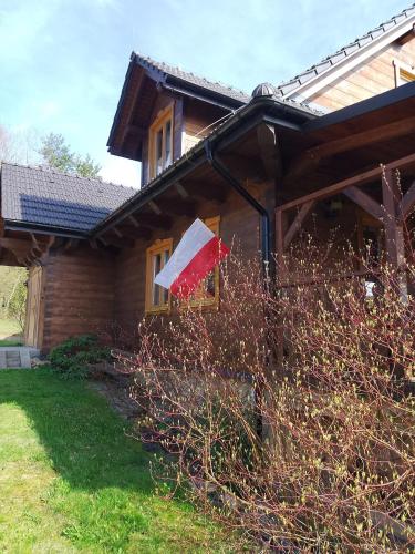 a flag hanging on the side of a house at ORLIK - pokoje gościnne in Uście Gorlickie