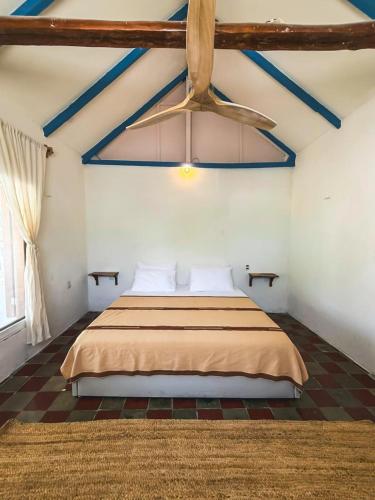 a bedroom with a bed in a room with a ceiling at Casa Martine in El Cuyo