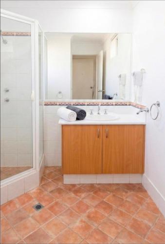 a bathroom with a tub and a sink and a shower at Cozy water side apartment - Jetty in Mandurah