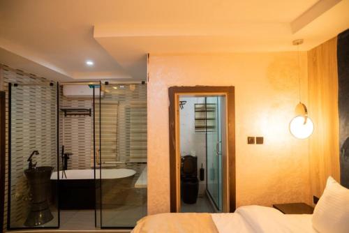 a bedroom with a shower and a bath tub at Trev Hotels and Suites in Asaba