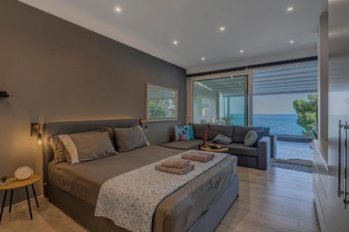 a bedroom with a large bed and a couch at Kalafatis beach home in Itea