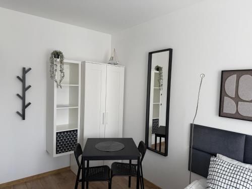a dining room with a table and a mirror at Apartamenty Dana in Pustkowo