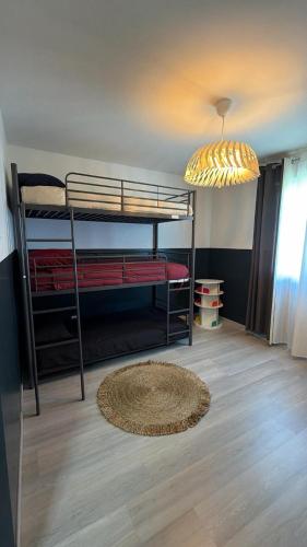 a room with two bunk beds and a chandelier at Villa Troyes piscine chauffée sans vis à vis et jacuzzi massant in Saint-André-les-Vergers